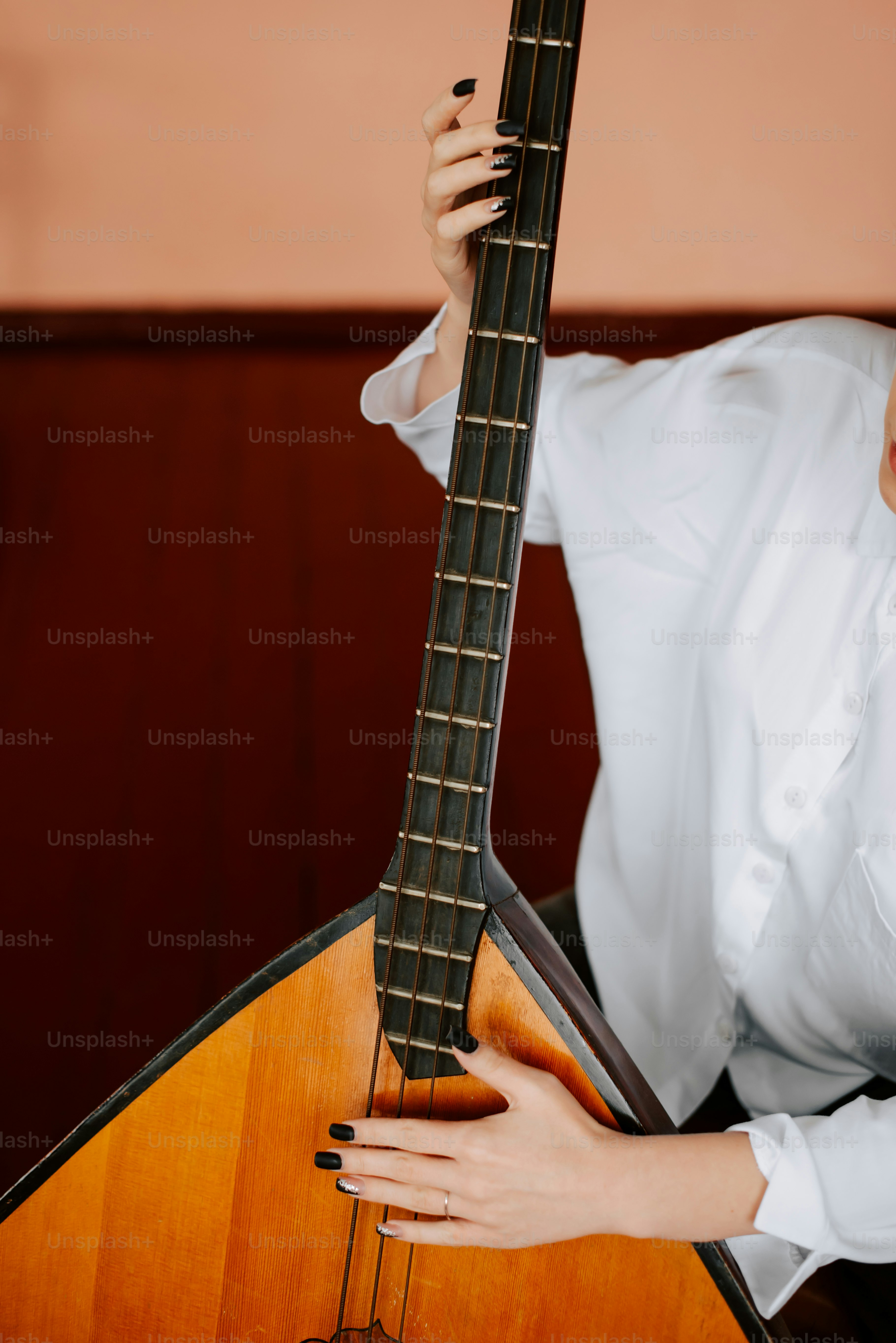 a woman holding a guitar in her right hand