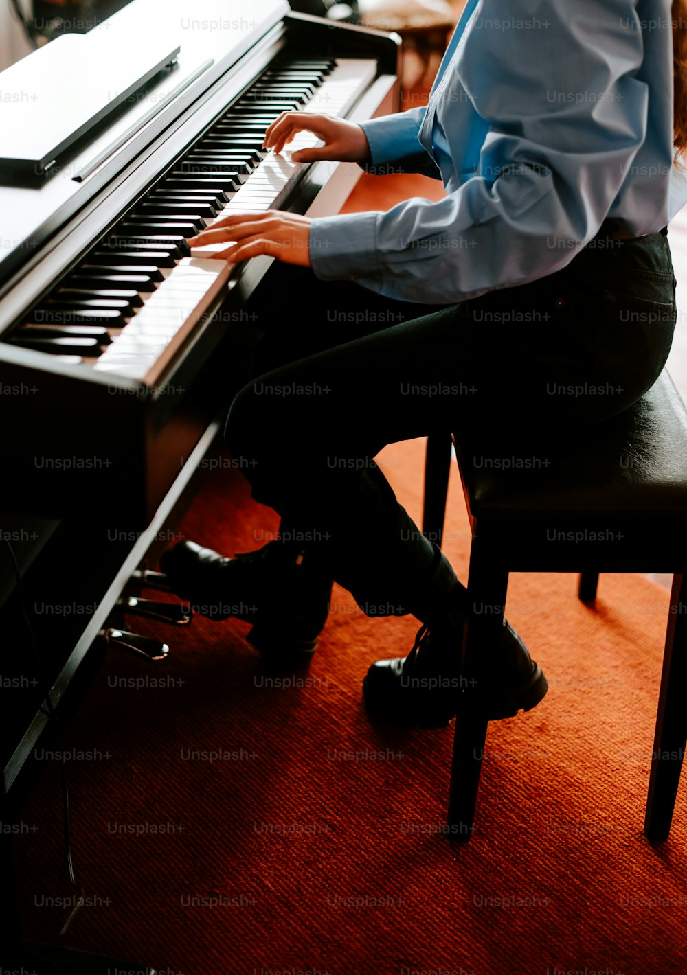 a man sitting at a piano in a room