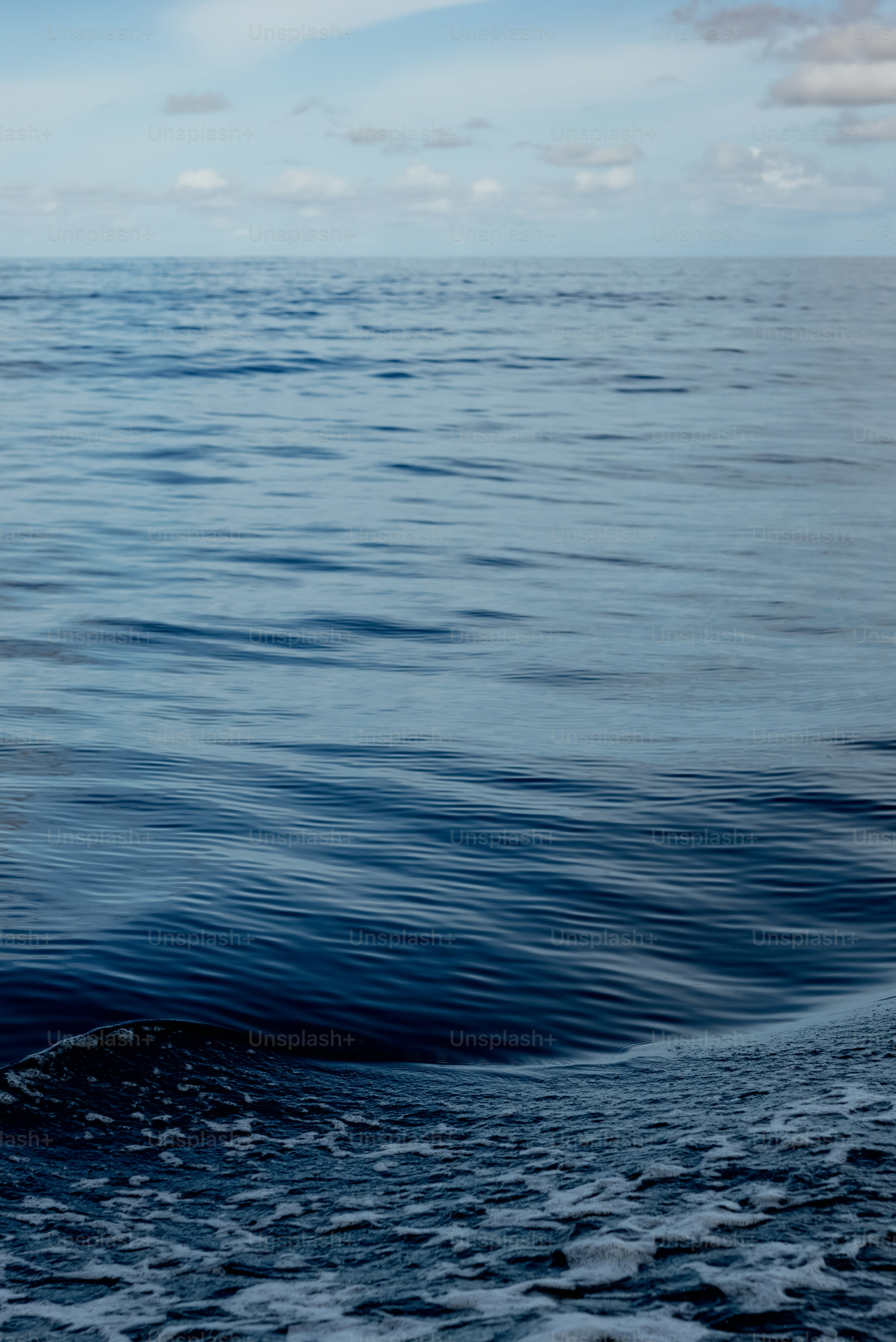 a man riding a surfboard on top of a wave in the ocean
