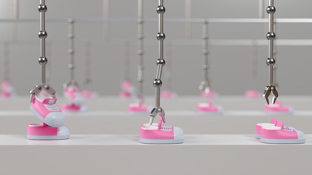 a row of pink and white shoes hanging from hooks