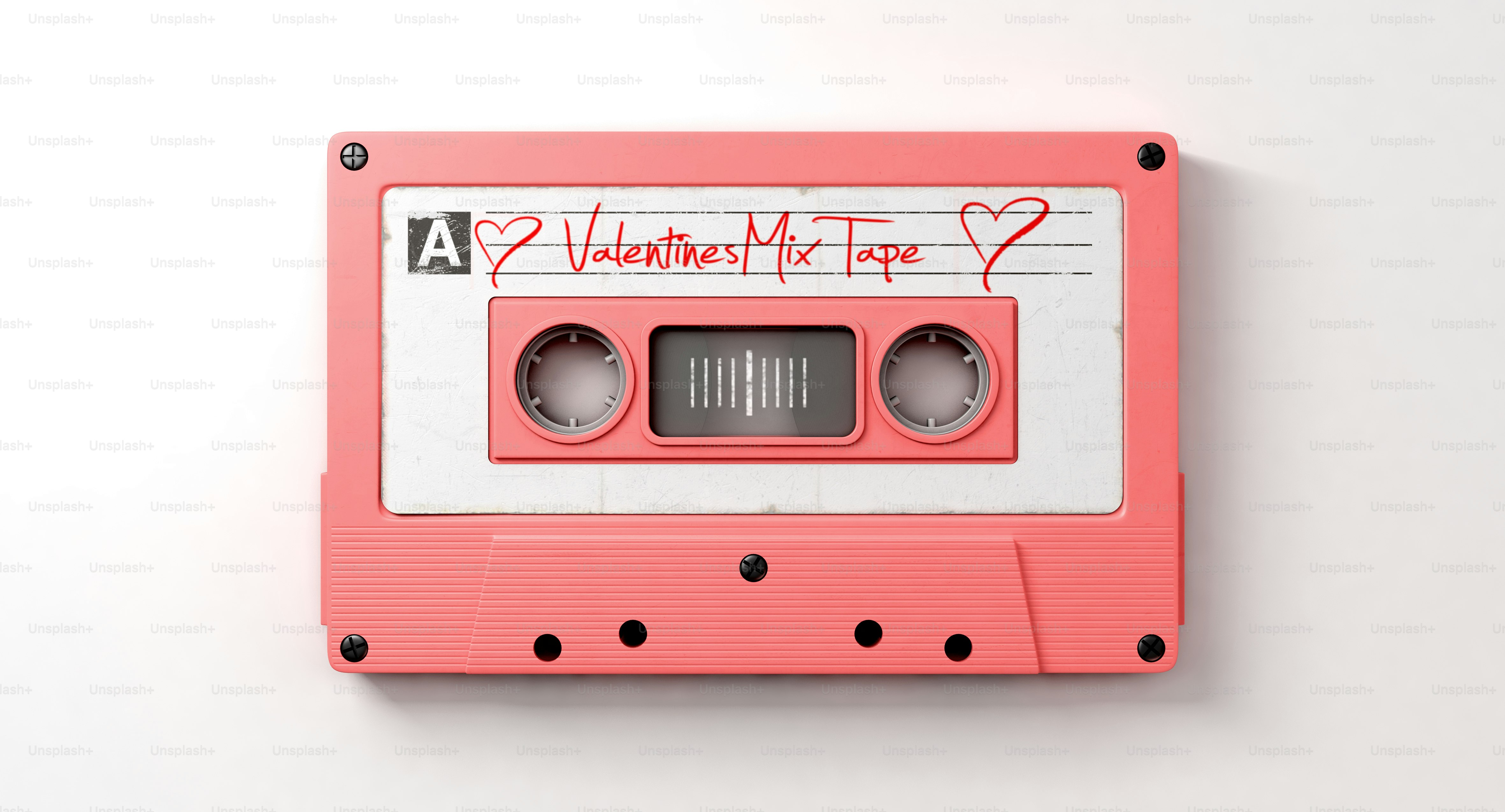 A close up view of a pink vintage audio cassette tape with a white label that reads mix tape on an isolated white background