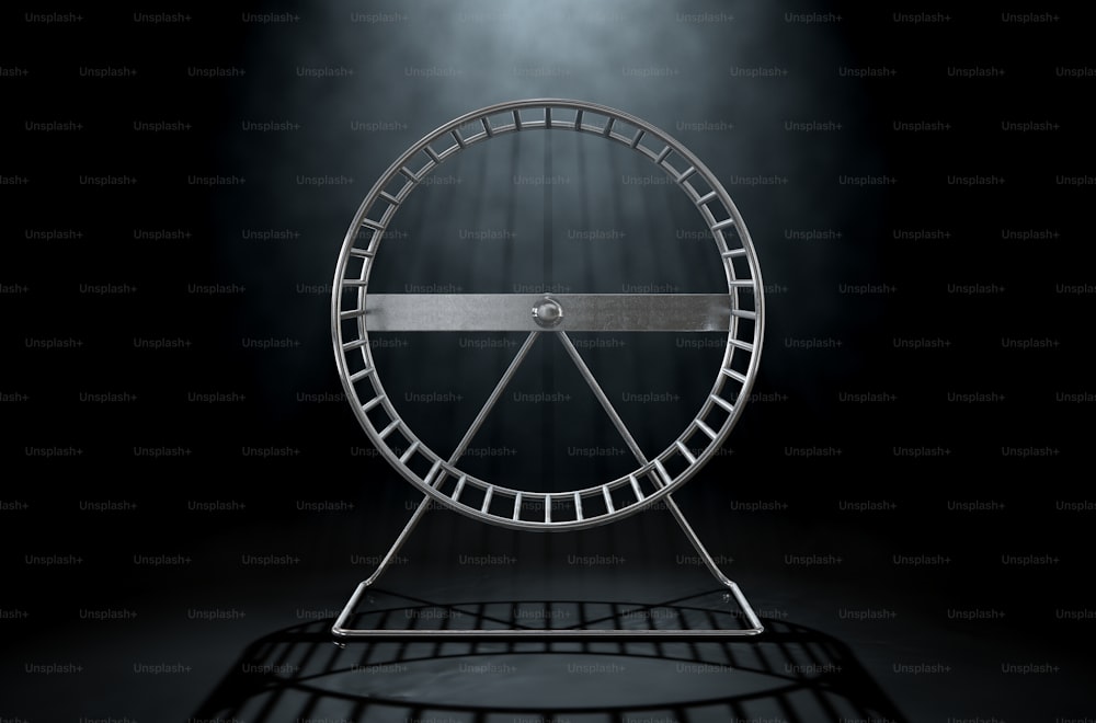 A 3D render of a close up of an empty regular hamster wheel made of metal on an isolated dark studio background