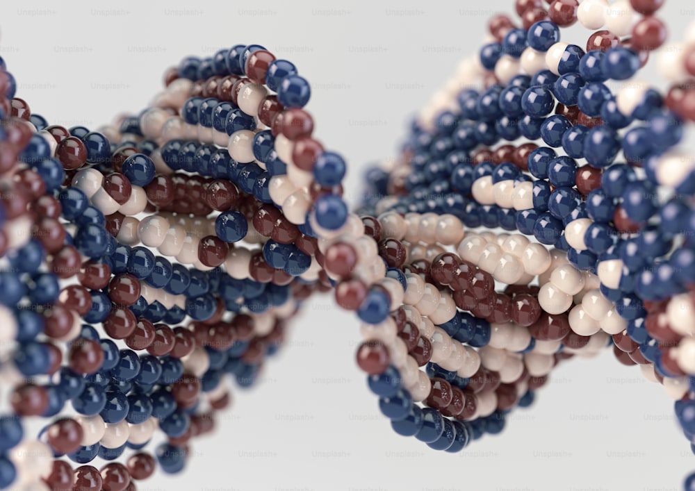 A model of a sequenced pattern of DNA style red blue and cream atom balls on an isolated background - 3D render