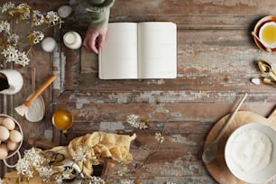 an open book on a wooden table next to a bowl of eggs