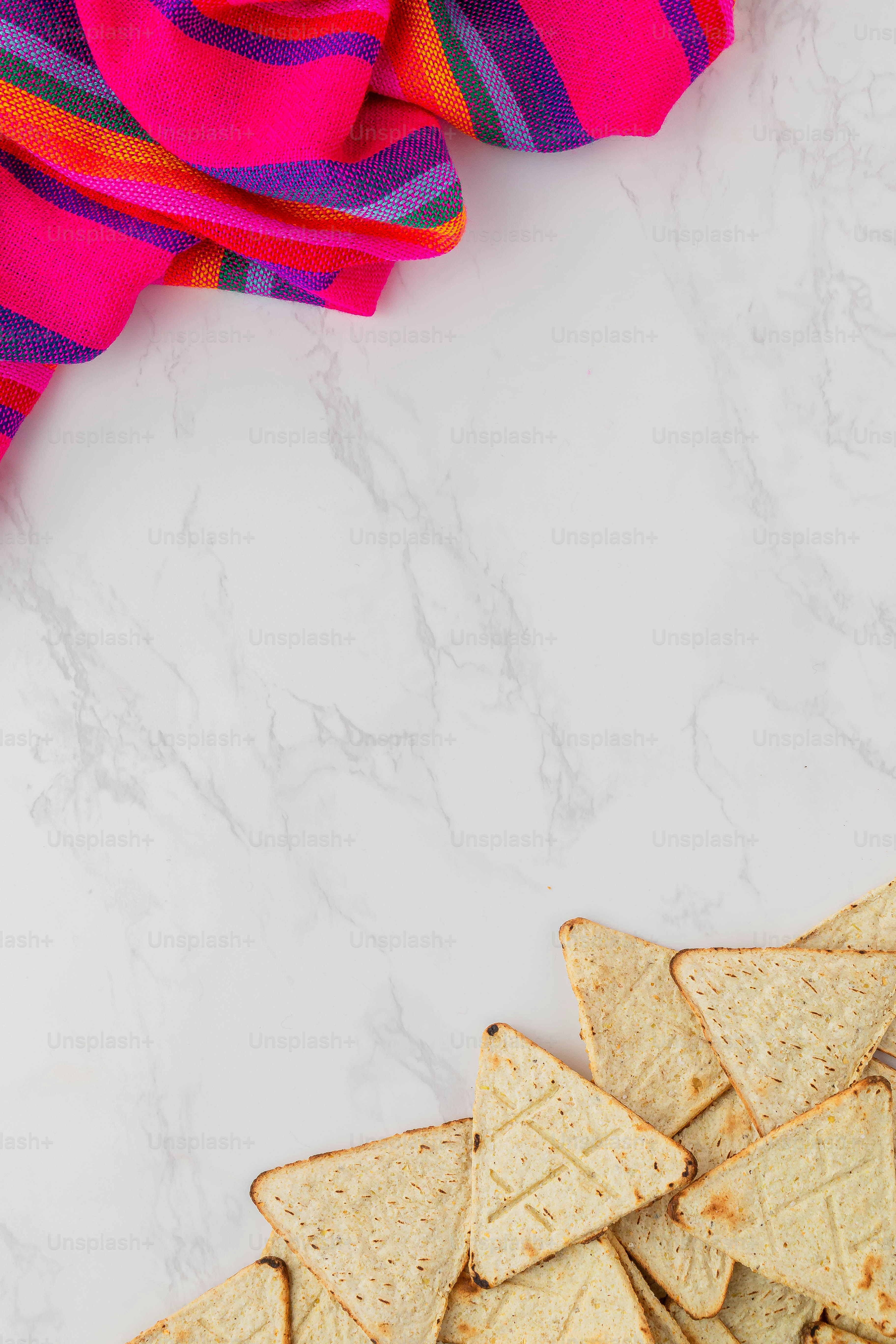a pile of tortilla chips sitting on top of a white counter