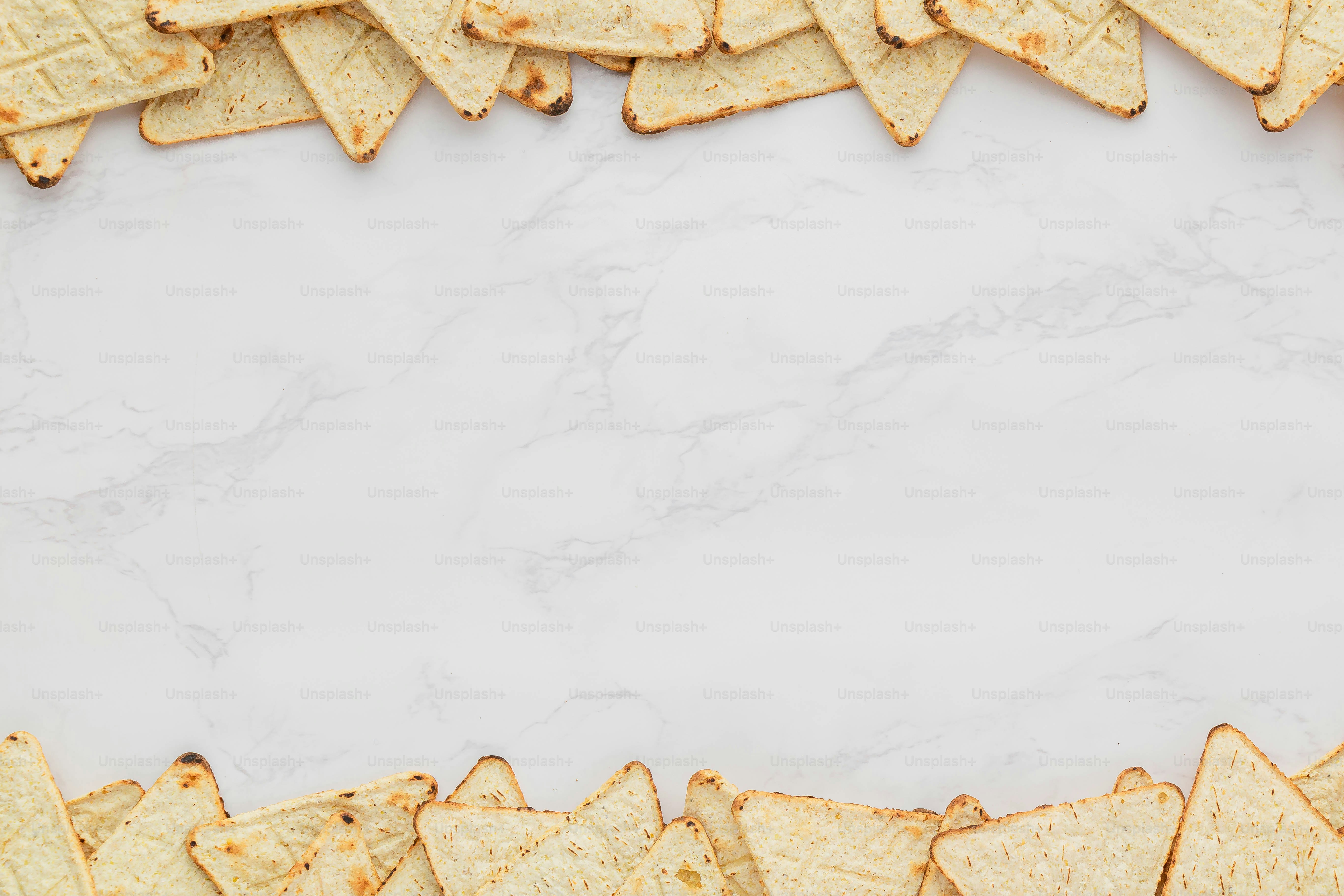 tortilla chips arranged on a white marble background