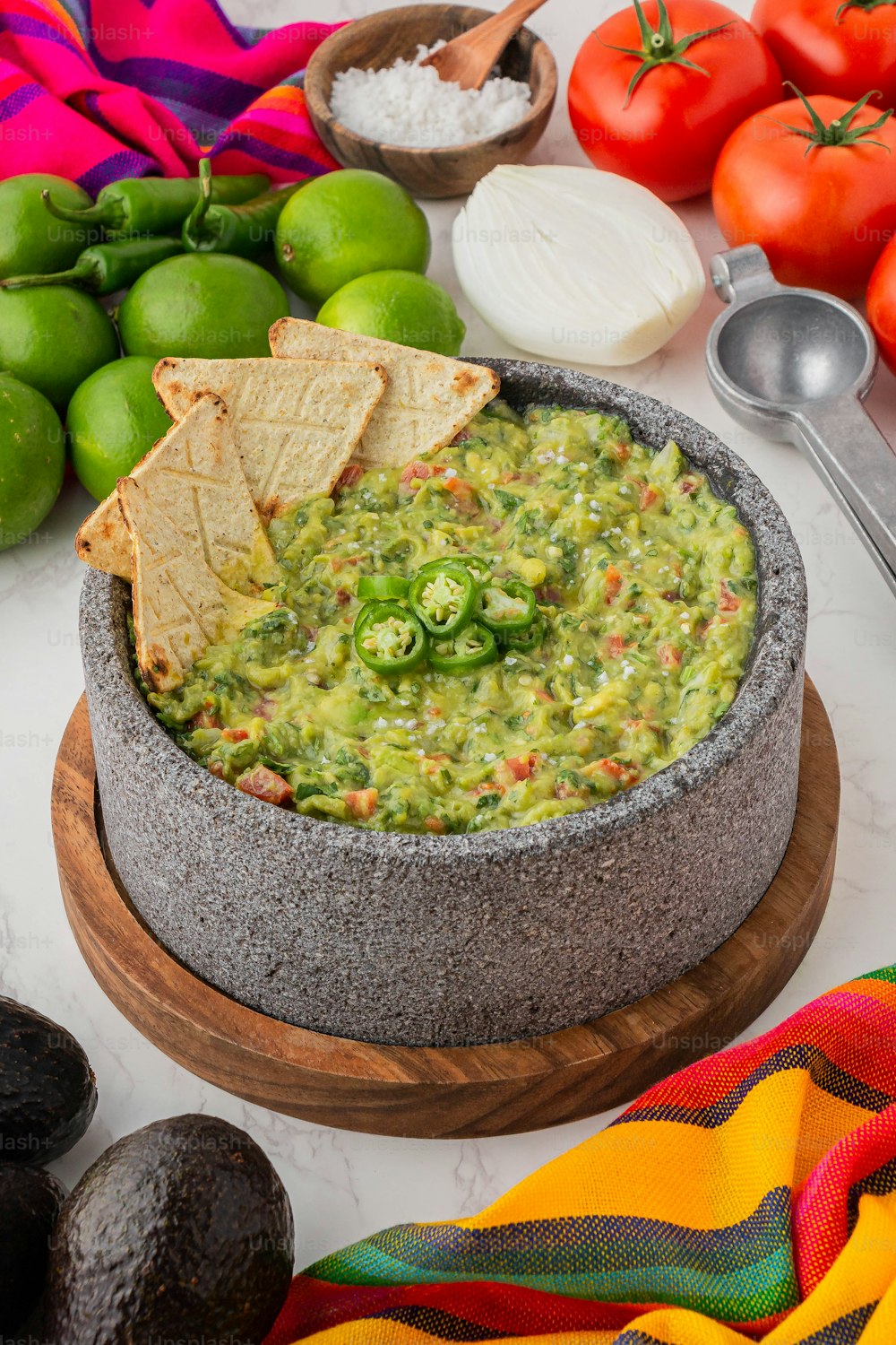 a bowl of guacamole with tortilla chips