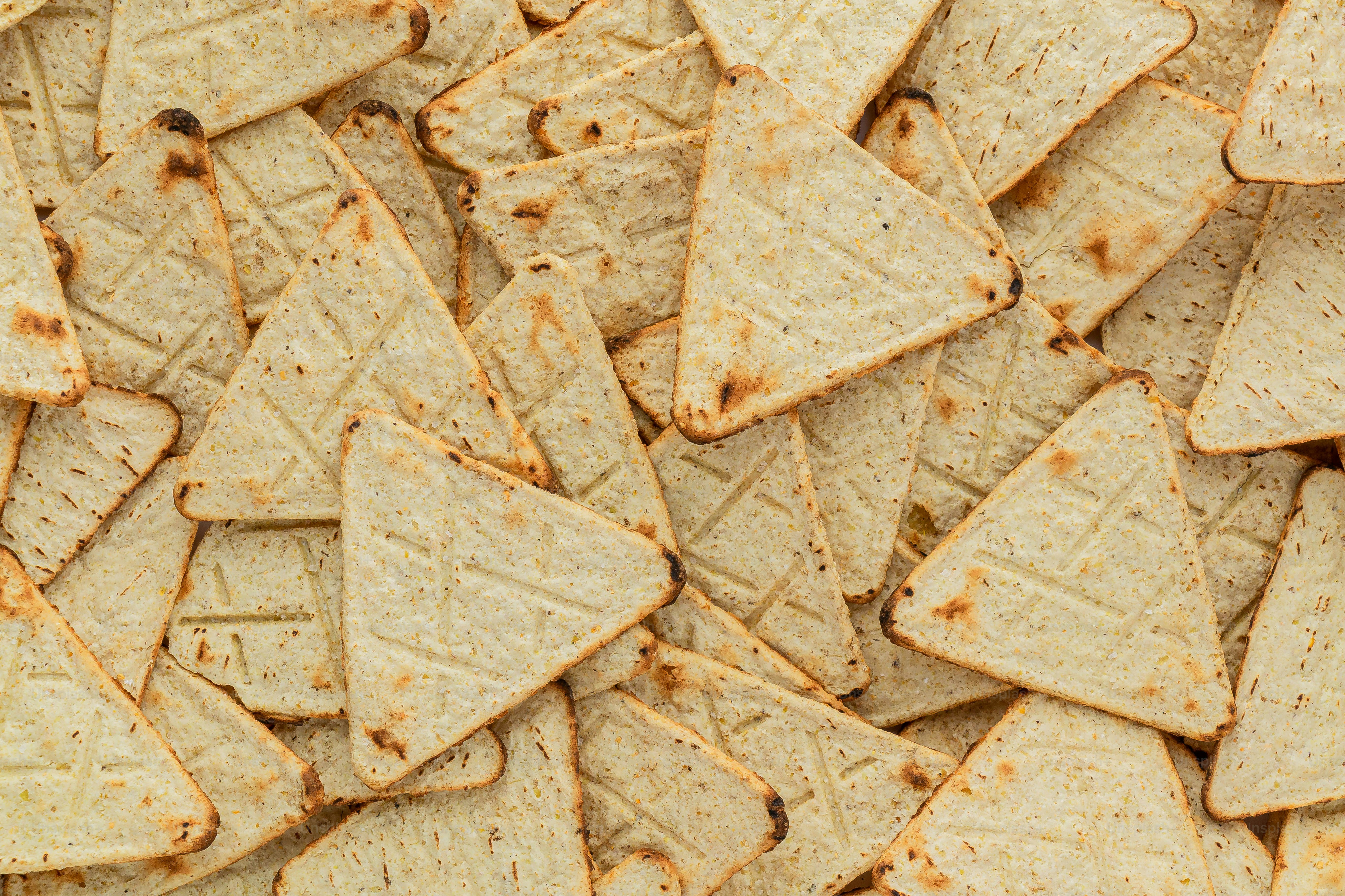 a pile of tortilla chips sitting on top of a table