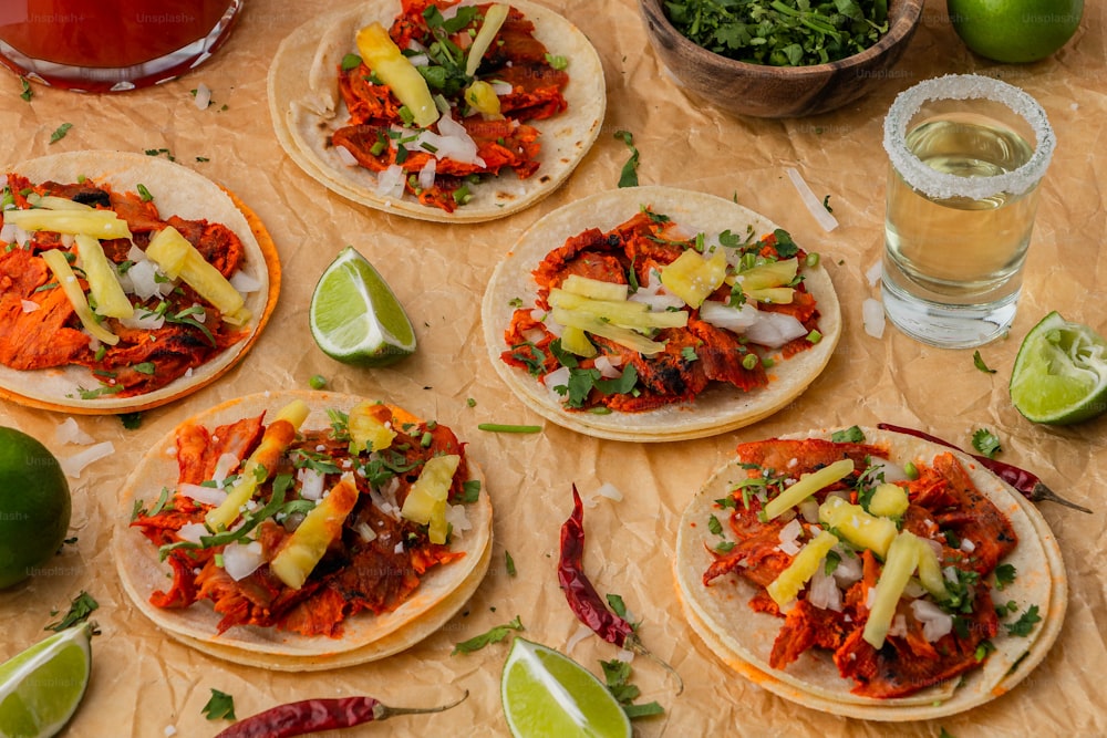 a table topped with tortillas covered in meat and veggies