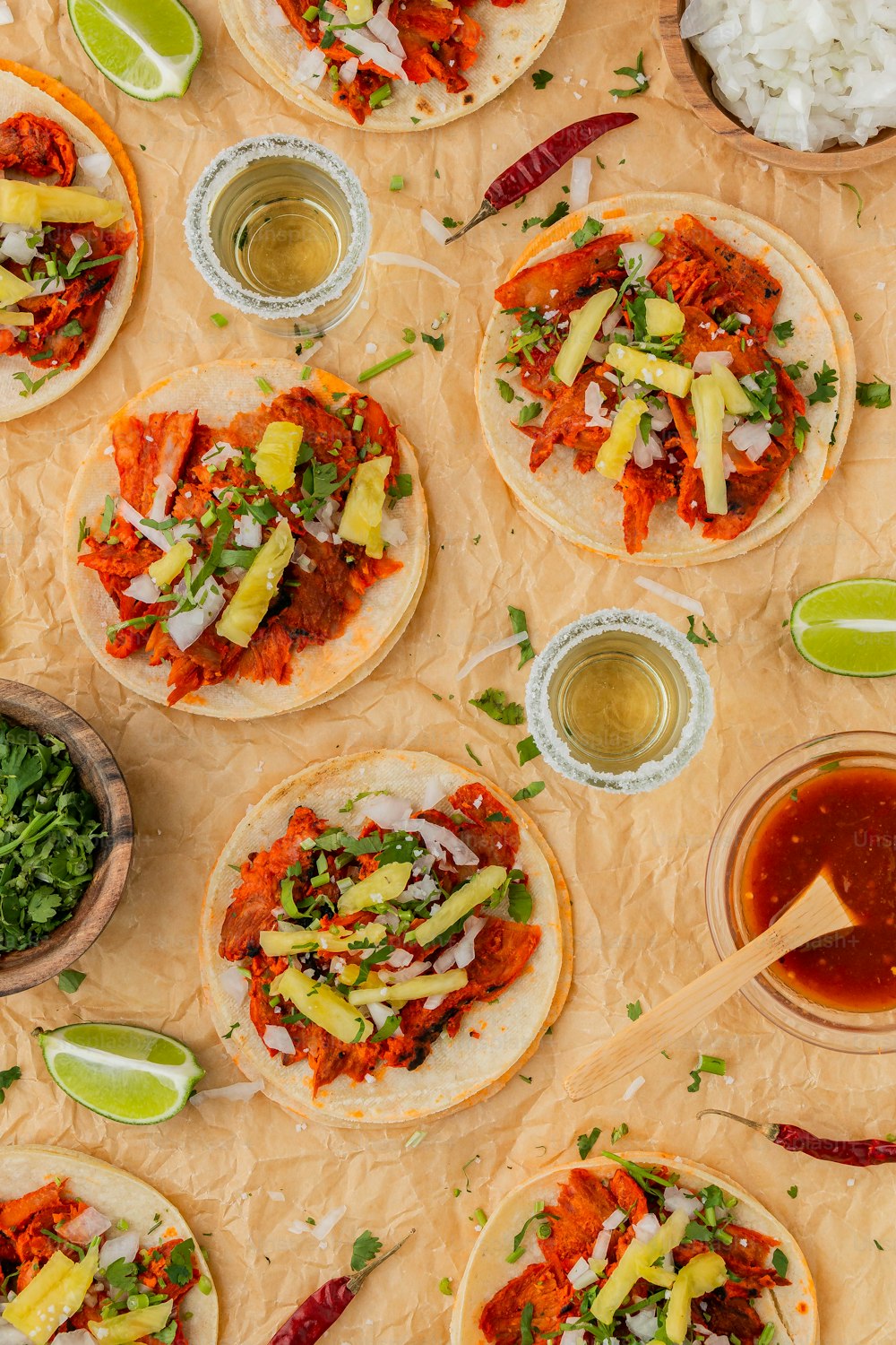 a table topped with tortillas covered in toppings