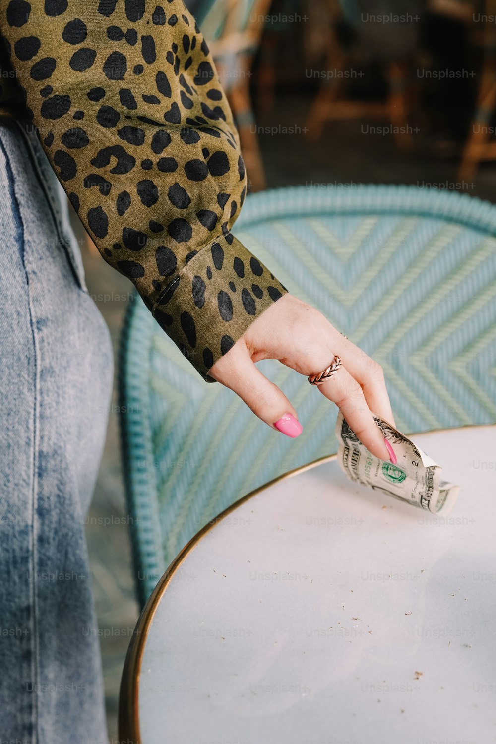 a woman's hand reaching for a stack of money