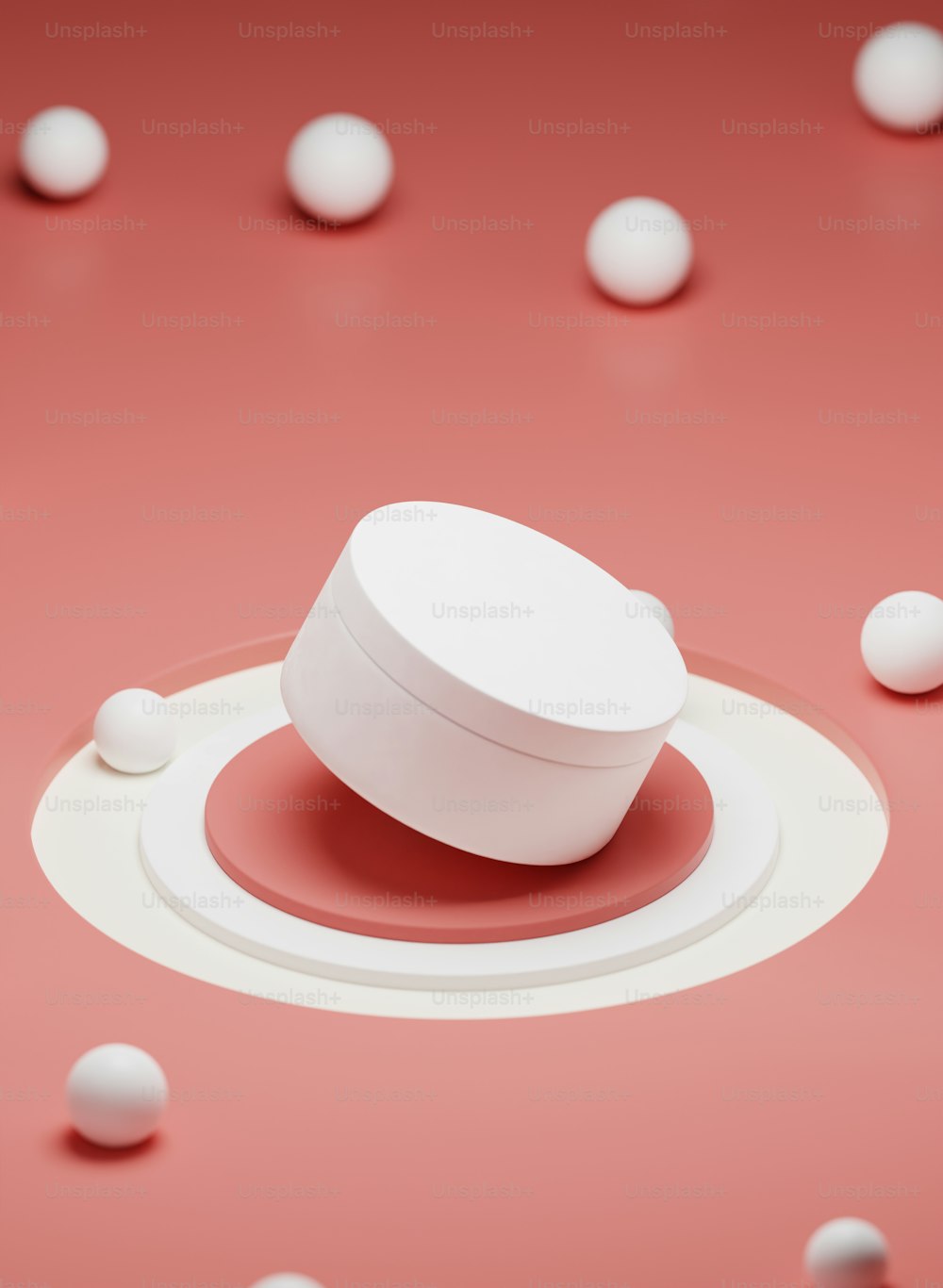 a white object sitting on top of a pink surface