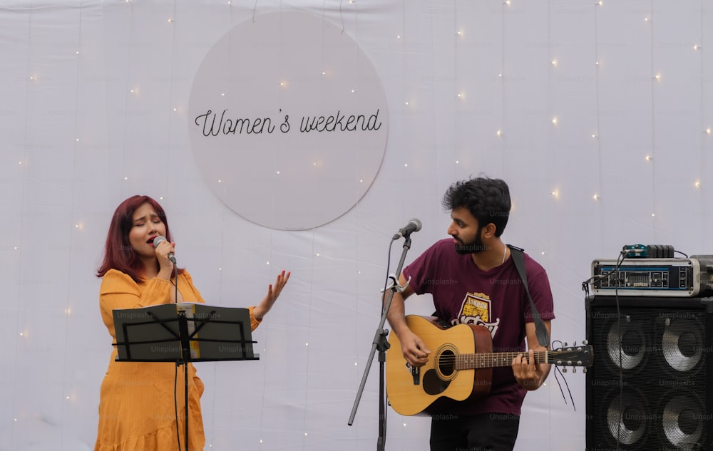 a man and a woman singing into a microphone