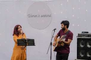 a man and a woman singing into a microphone