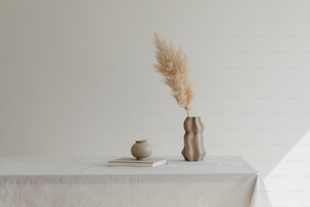 a table with a vase and a book on it