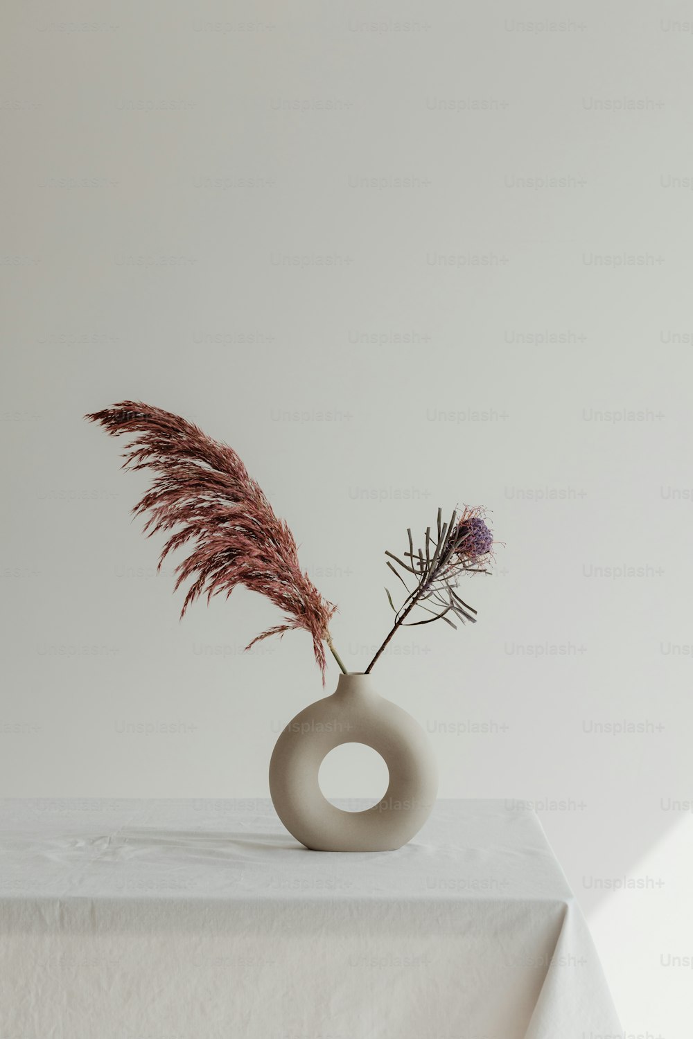 un vase avec une plante dedans assis sur une table
