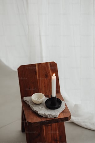 a wooden chair with a candle on top of it