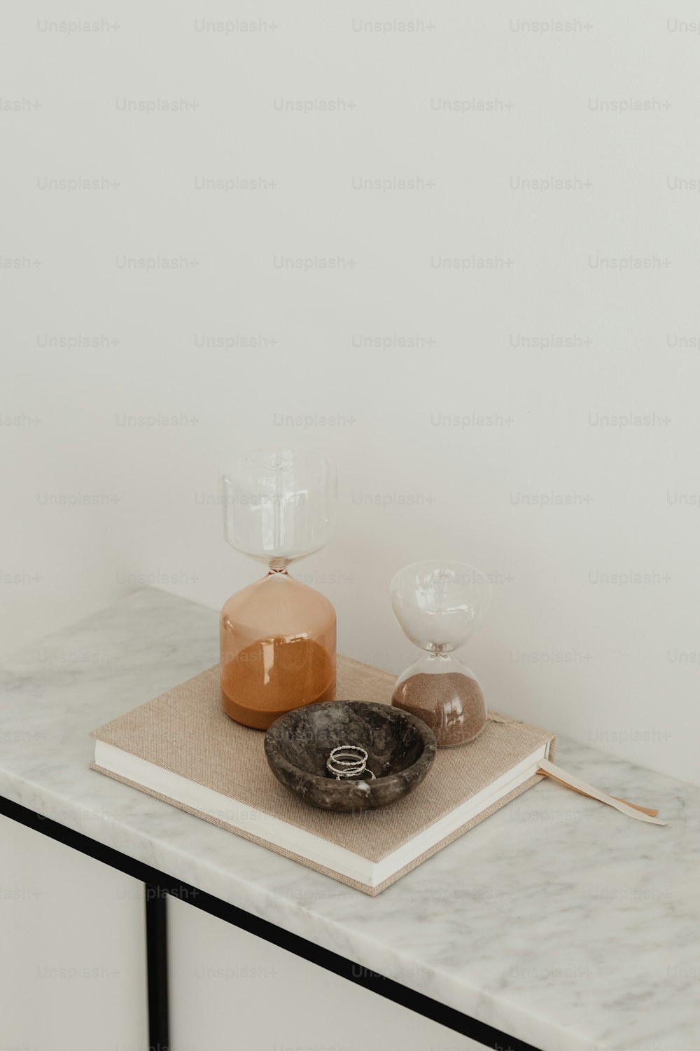 a marble tray with a candle and a glass on it