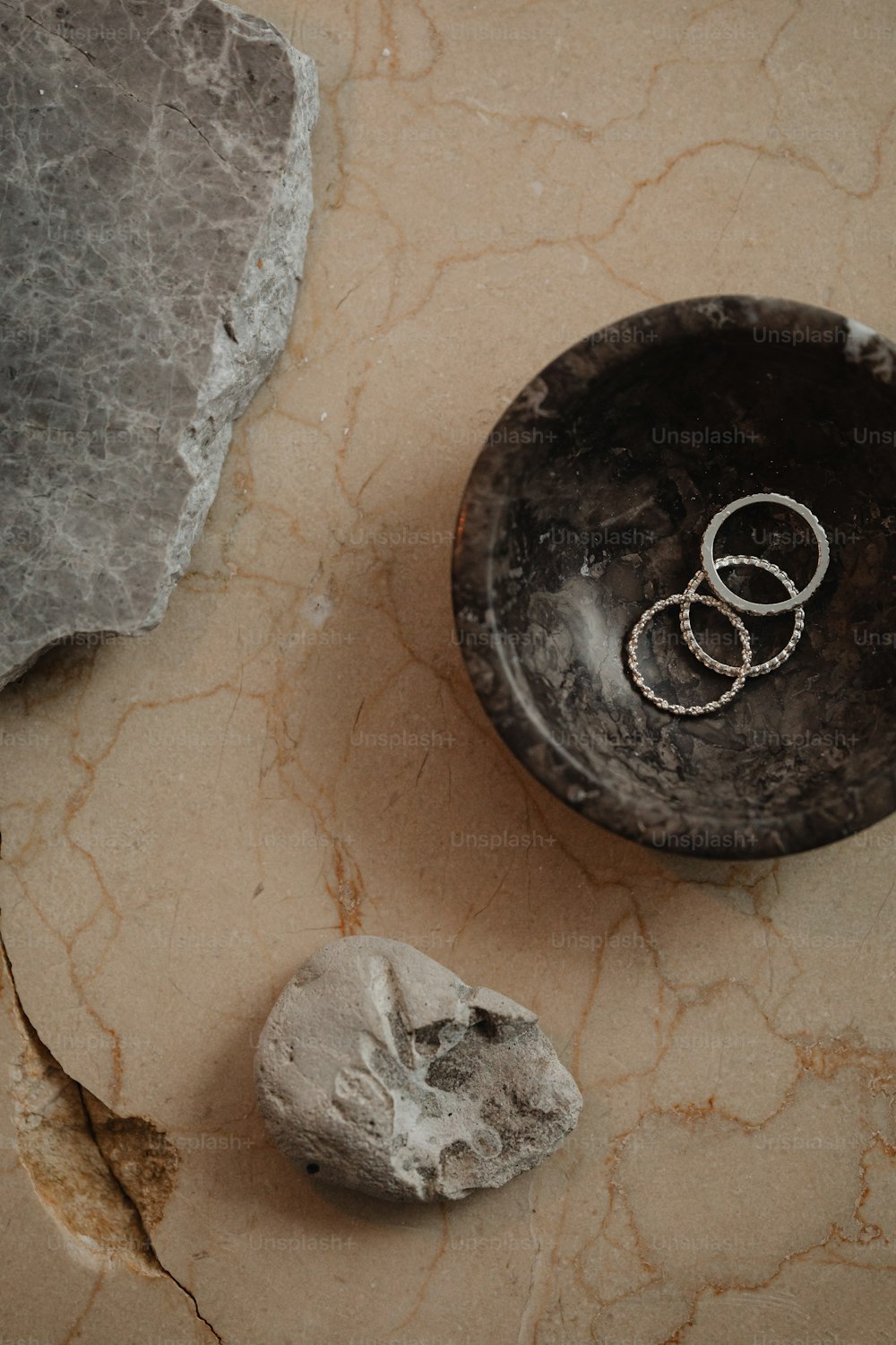 a couple of rings sitting on top of a rock