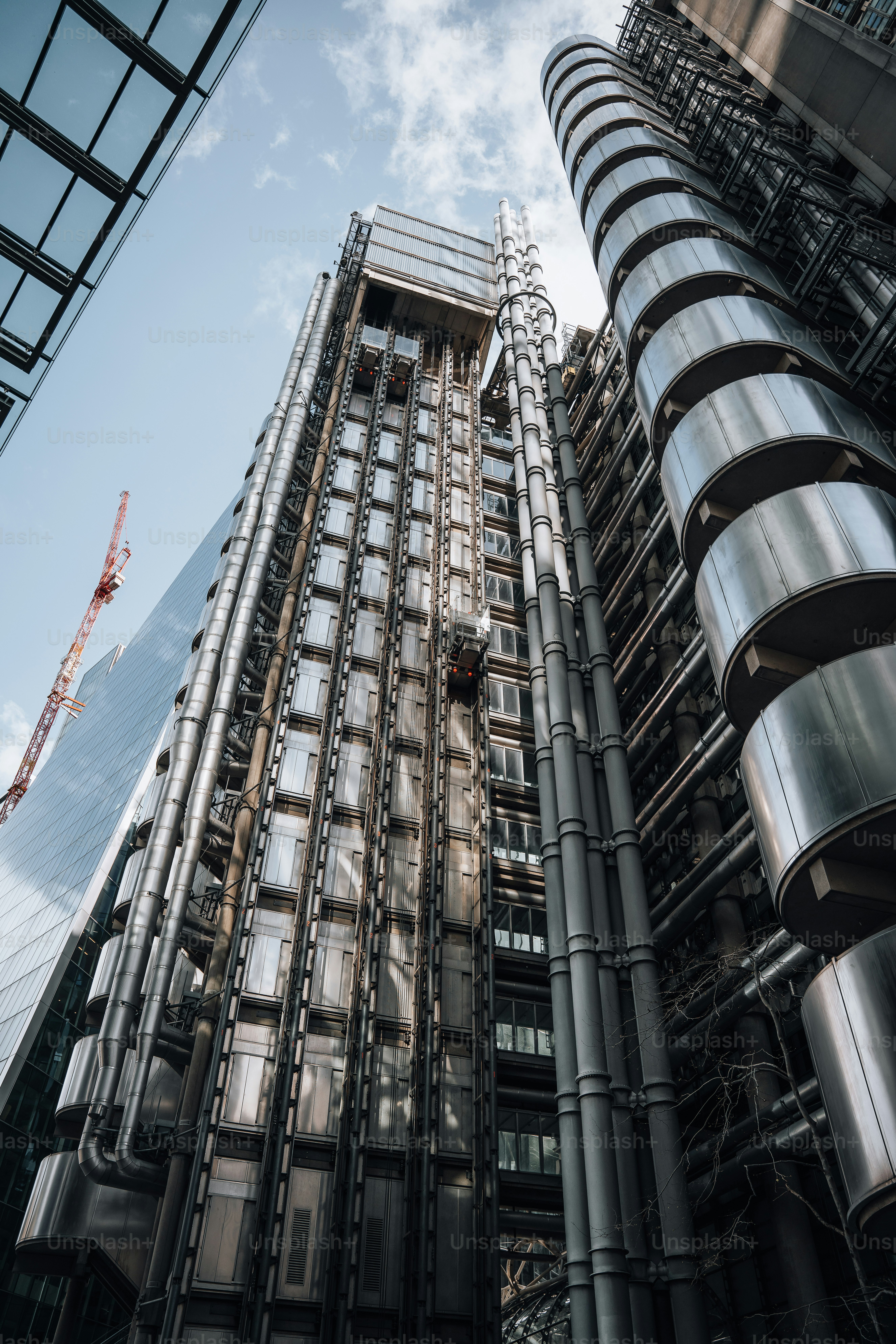 a tall building with lots of windows next to a crane