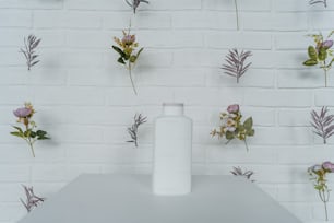 a white vase sitting on top of a white table