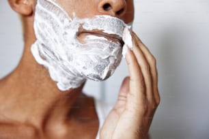 a man shaving his face with a shaving razor