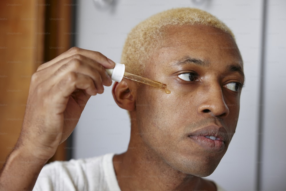 a man with a yellow hair combing his hair