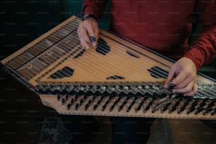 a man is holding a musical instrument in his hands