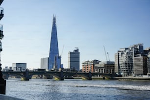 a view of a river with a bridge in the foreground