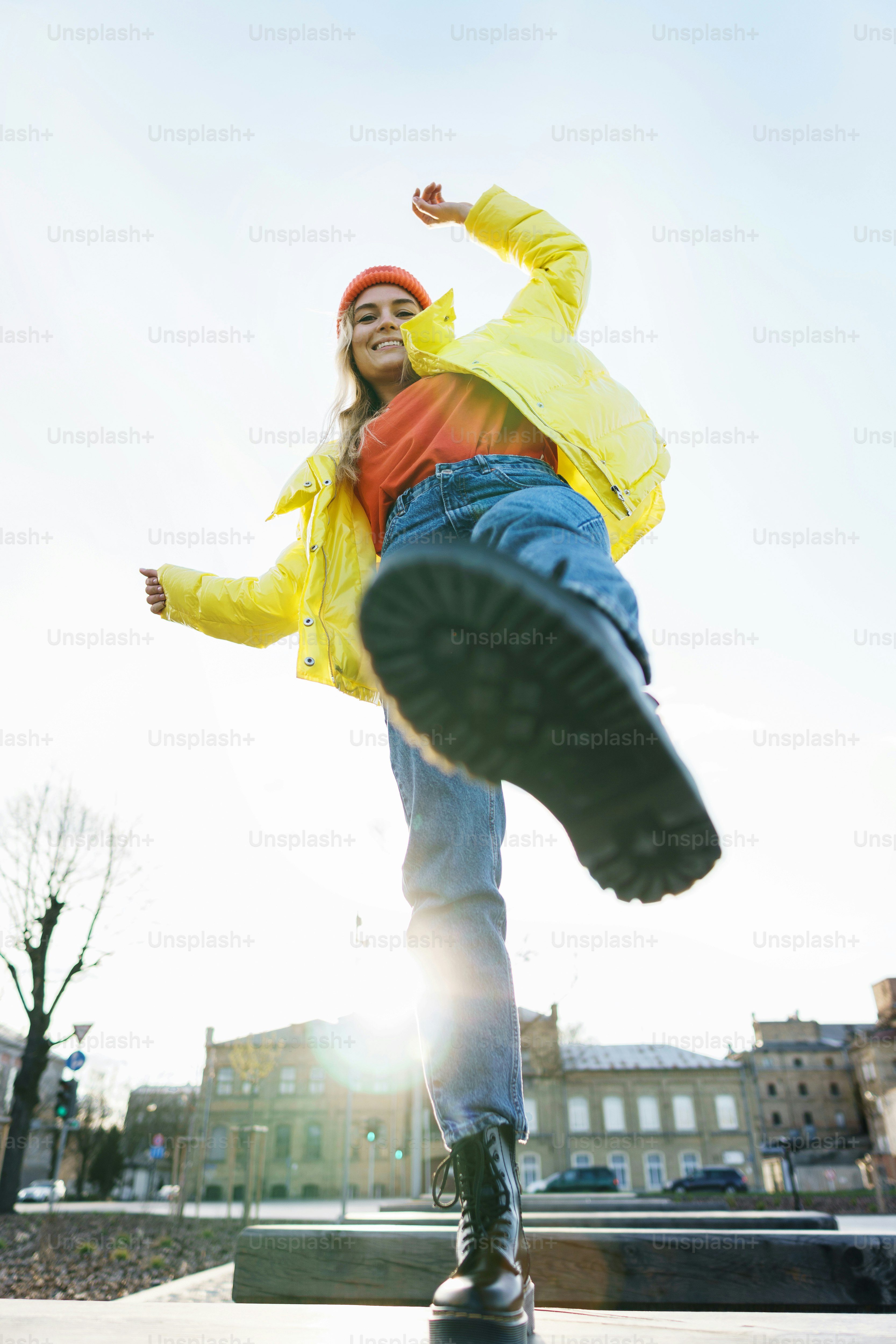 Portrait of  stylish girl wearing yellow puffer and orange knitted hat
