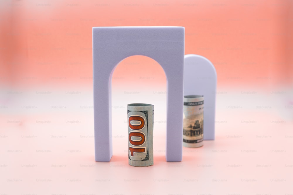 a can of soda sitting in front of a small arch