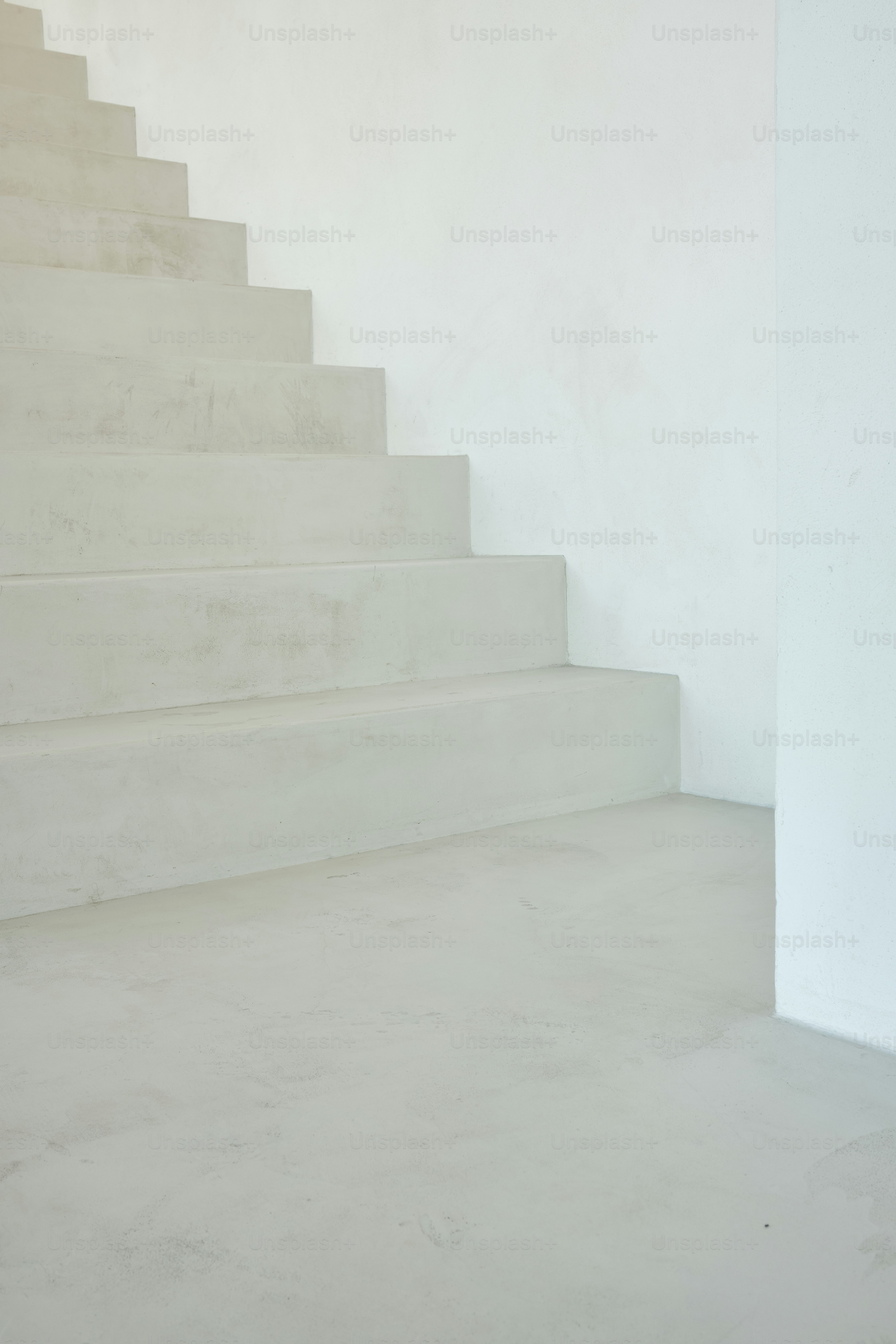 a cat sitting on a set of white stairs