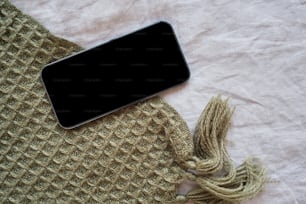 a cell phone laying on top of a blanket