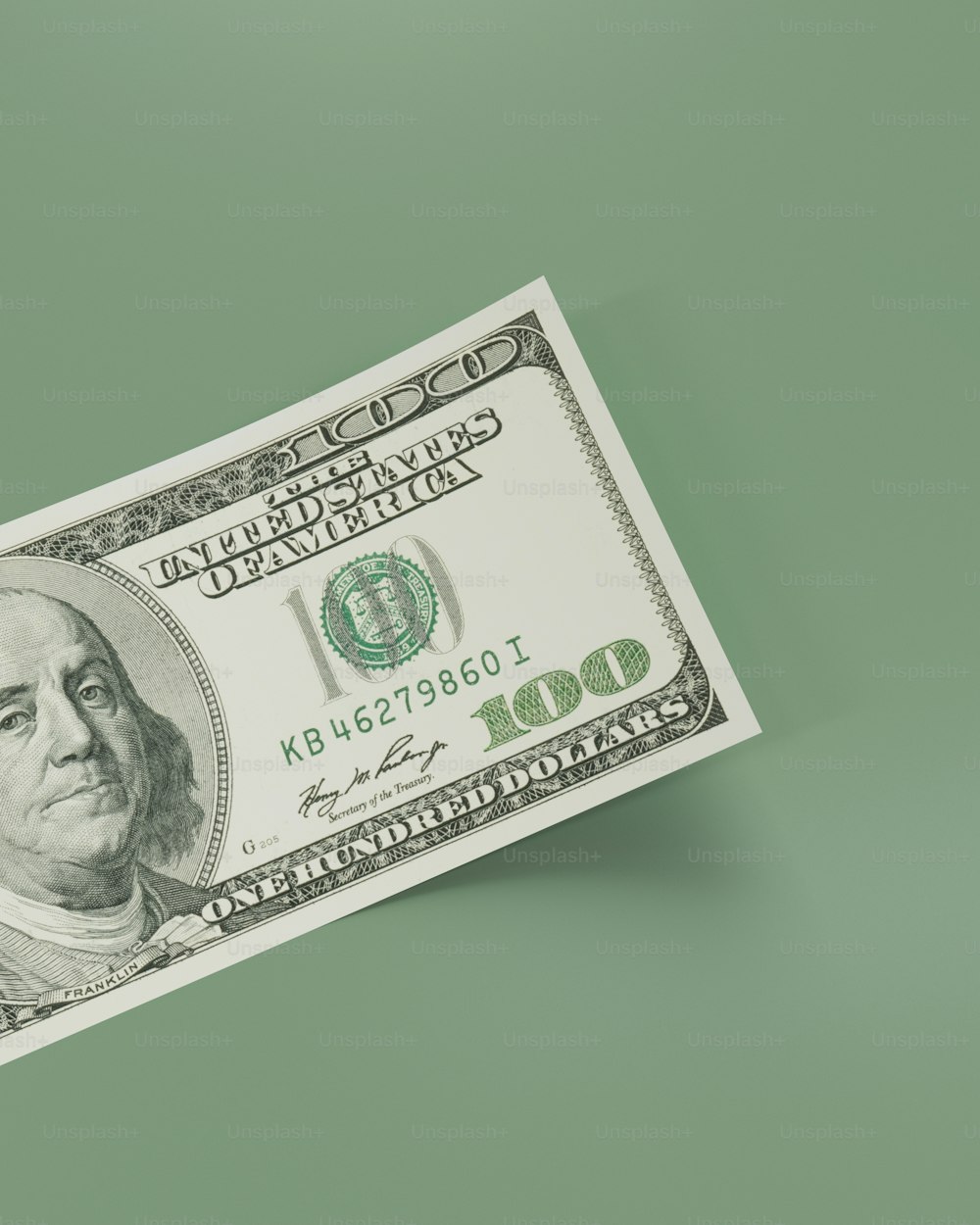 a one hundred dollar bill on a green background