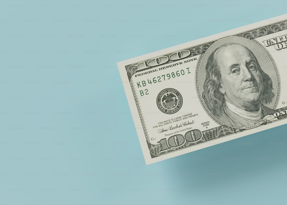a hundred dollar bill on a blue background