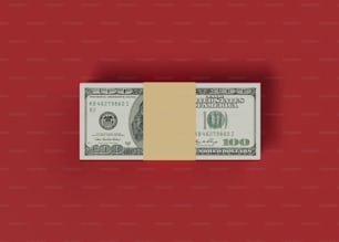 a stack of one hundred dollar bills on a red background