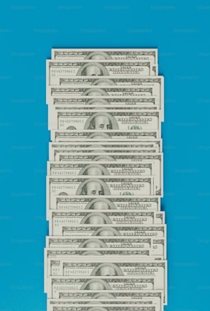 a stack of twenty dollar bills on a blue background