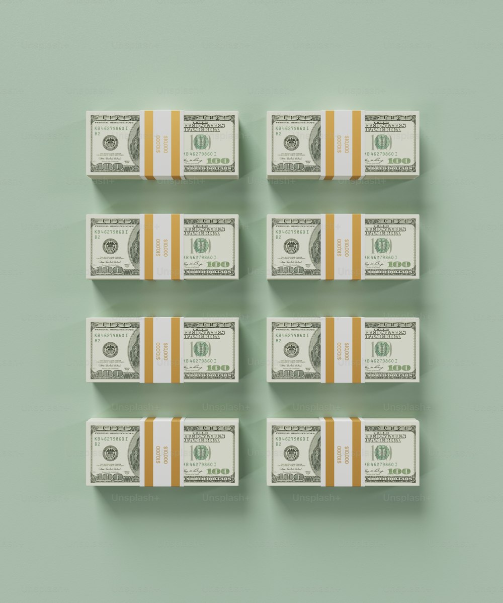 six stacks of one hundred dollar bills on a green background