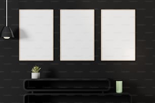 Una habitación negra con tres marcos blancos en la pared
