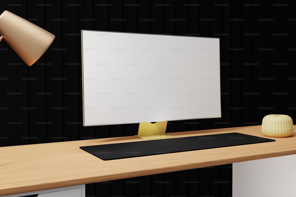 um monitor de computador sentado em cima de uma mesa de madeira