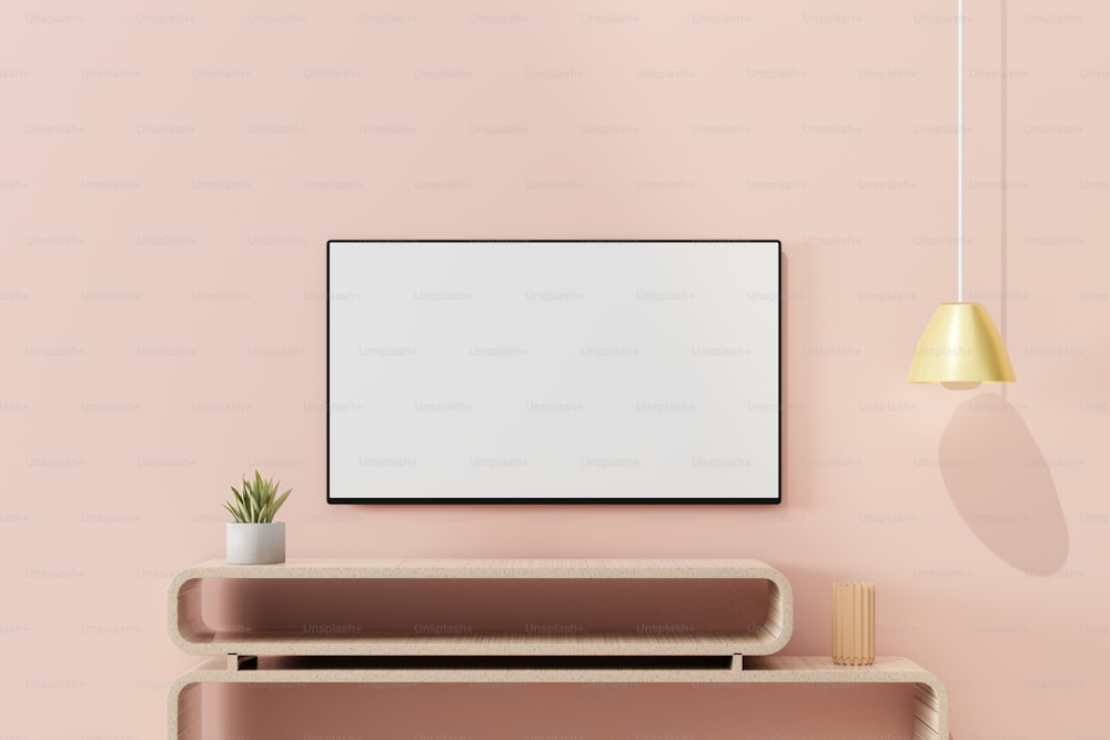 Una habitación rosa con un estante, una planta y un marco de fotos