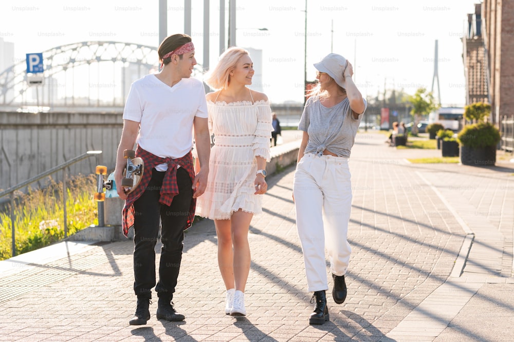 Enjoying freedom. Three happy teenage friends are walking in a city
