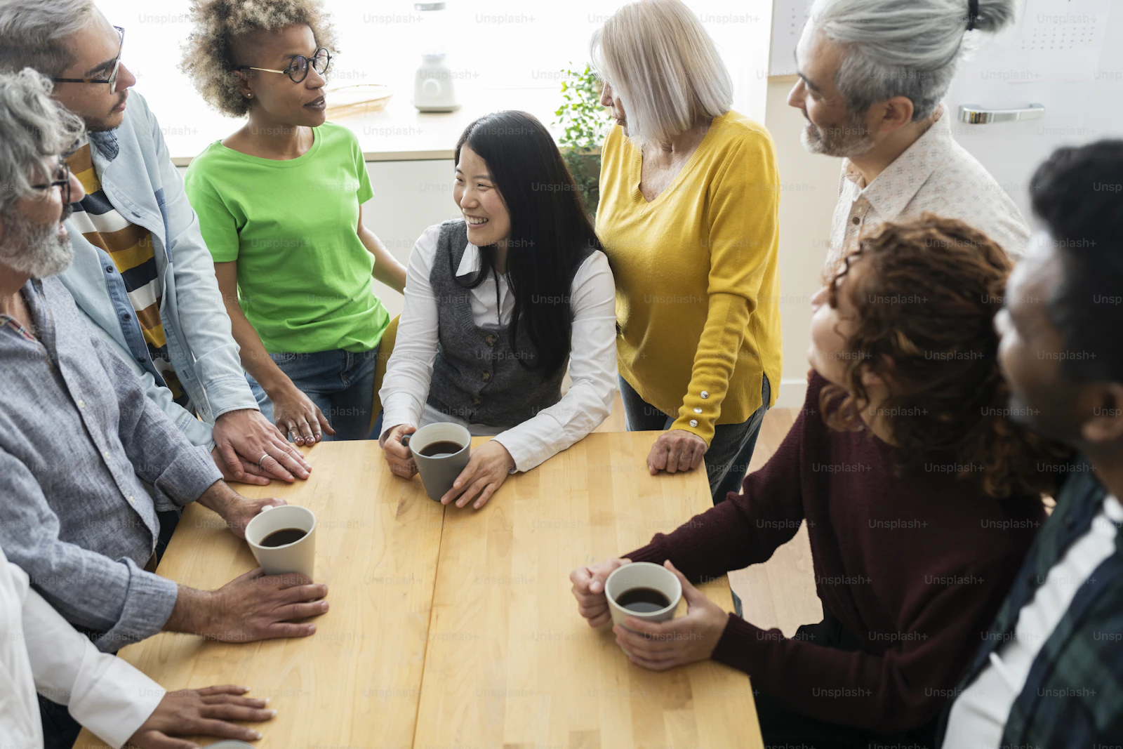 Neighbors talking together around a table at a community workshop