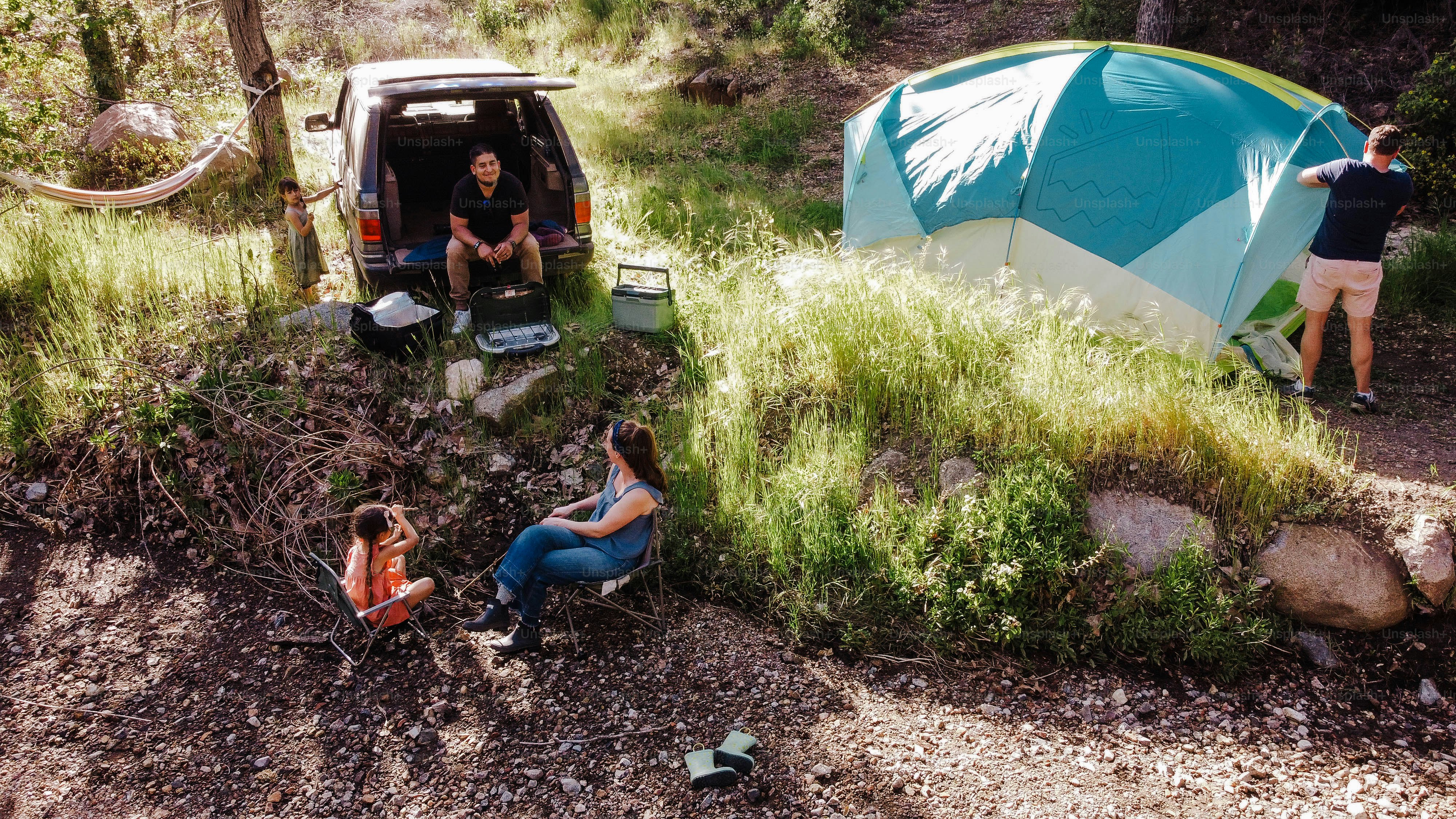 a couple of people sitting in the back of a van