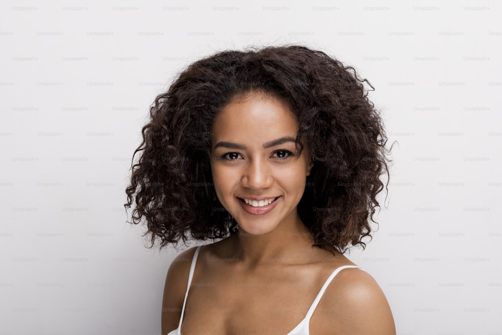 Studio portrait of a beautiful brunette woman, looking at camera