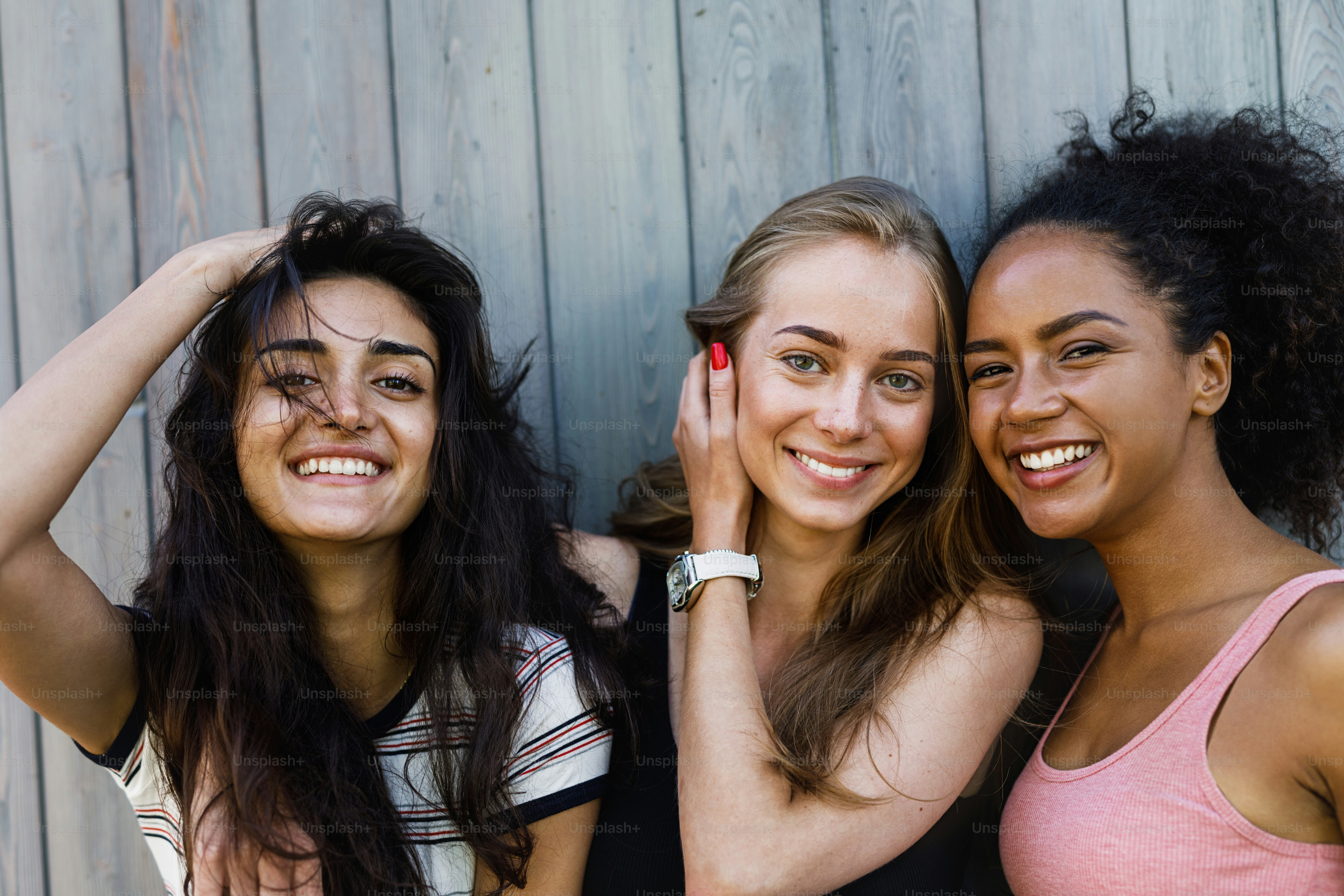 Multiracial female friends having fun outdoors, looking at camera photo ...