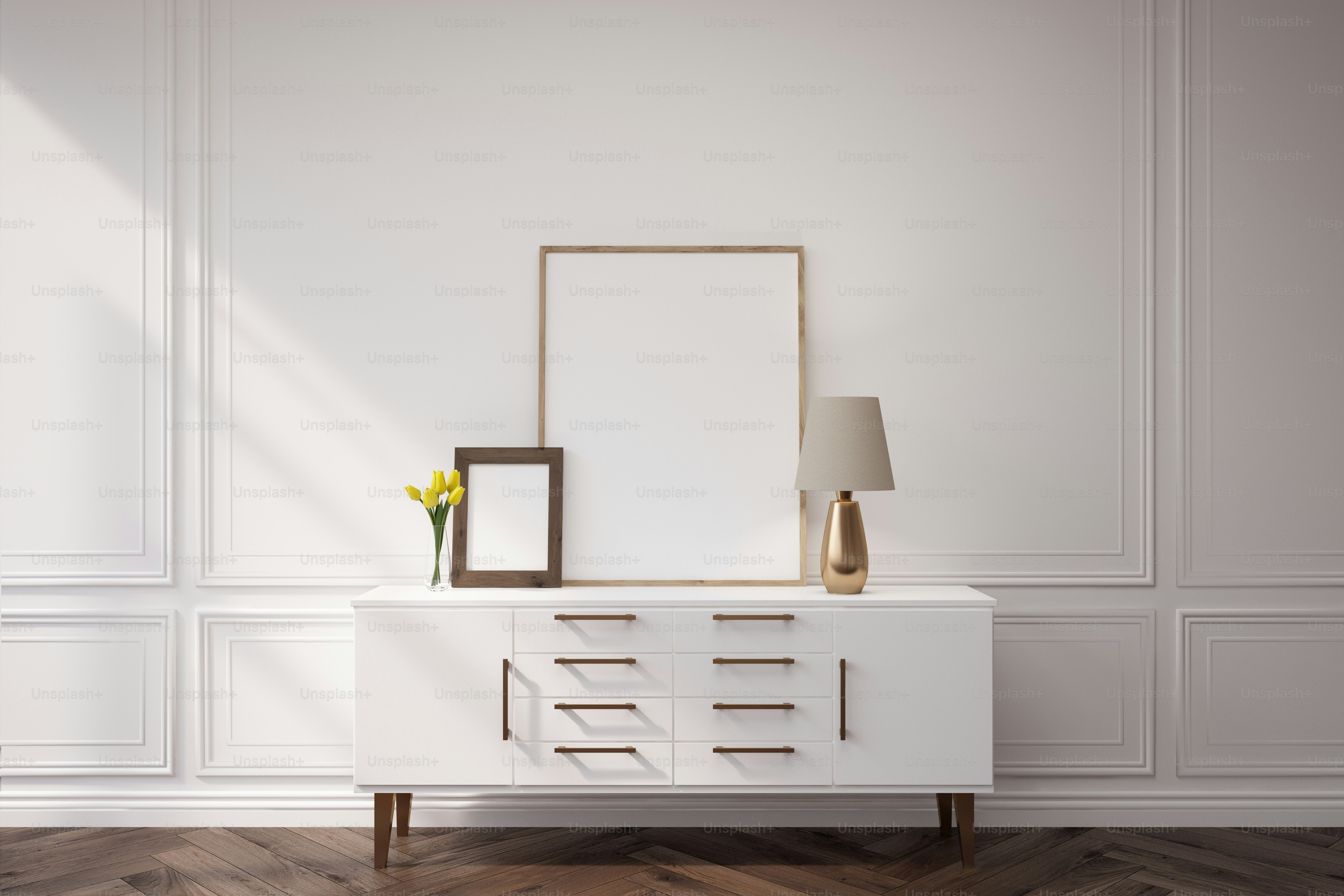 White cabinet is standing in a room with white walls. There are two framed pictures and a lamp. 3d rendering. Mock up