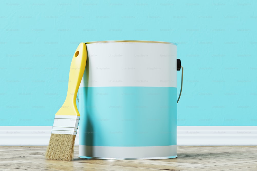 Close up of a blue paint bucket standing on a wooden floor against a blue wall with a large paintbrush near it. 3d rendering mock up