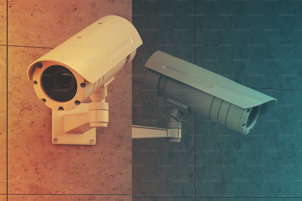 Close up of two white CCTV cameras attached to a blank gray wall outside. Concept of security and surveillance. 3d rendering toned image