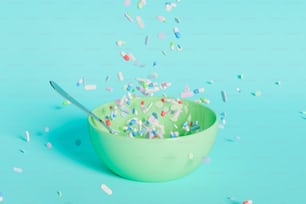 Green ceramic bowl with a spoon inside and many pills falling into it. Blue background. 3d rendering